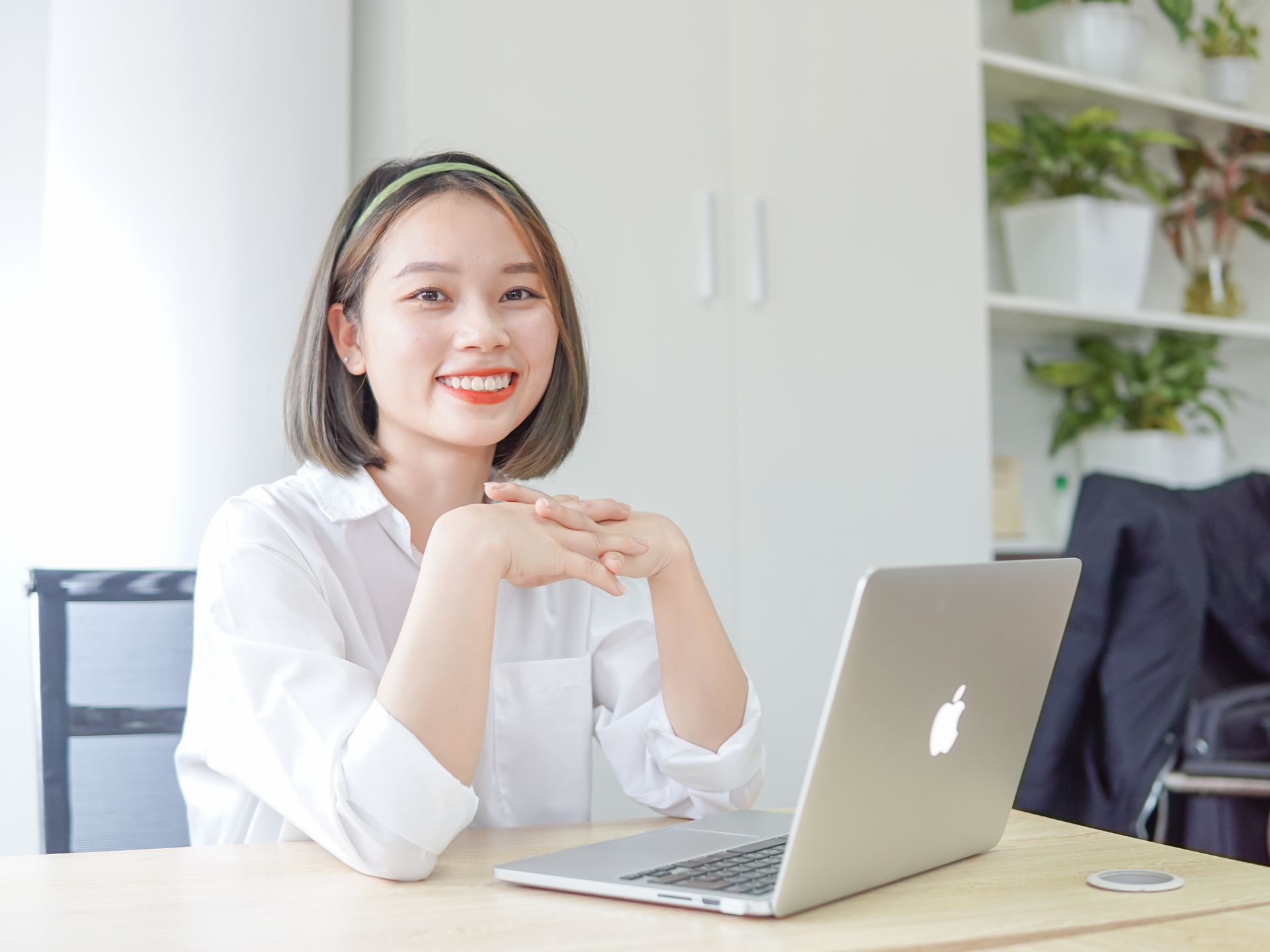 Happy business owner smiling with her laptop